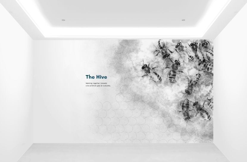A wall mural titled 'The Hive,' with a black and white image of bees on a honeycomb to represent teamwork.