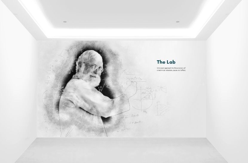 A wall mural titled 'The Lab,' featuring a black and white sketch of an engineer writing complex formulas on a board.