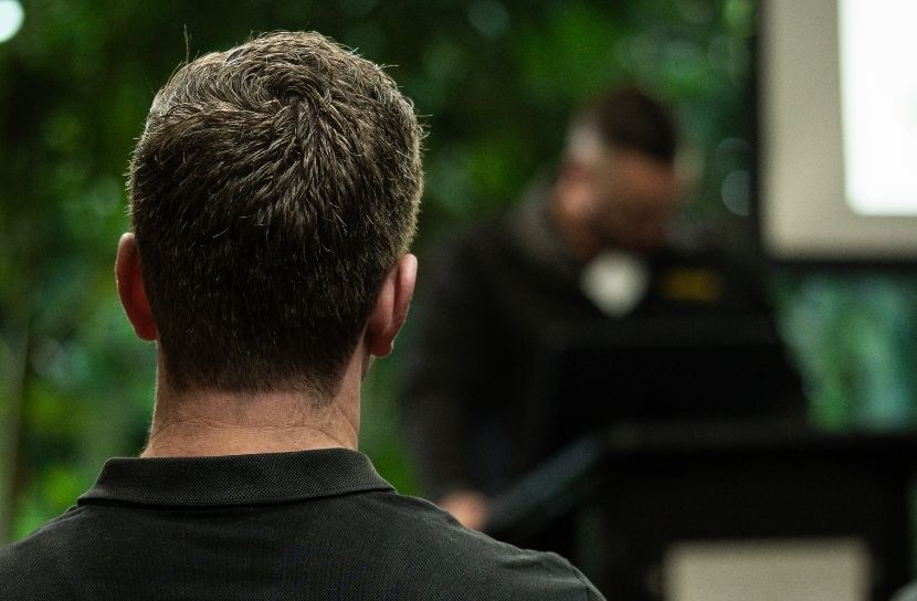 Person listening to Sam Pusey from Arborcraft speak