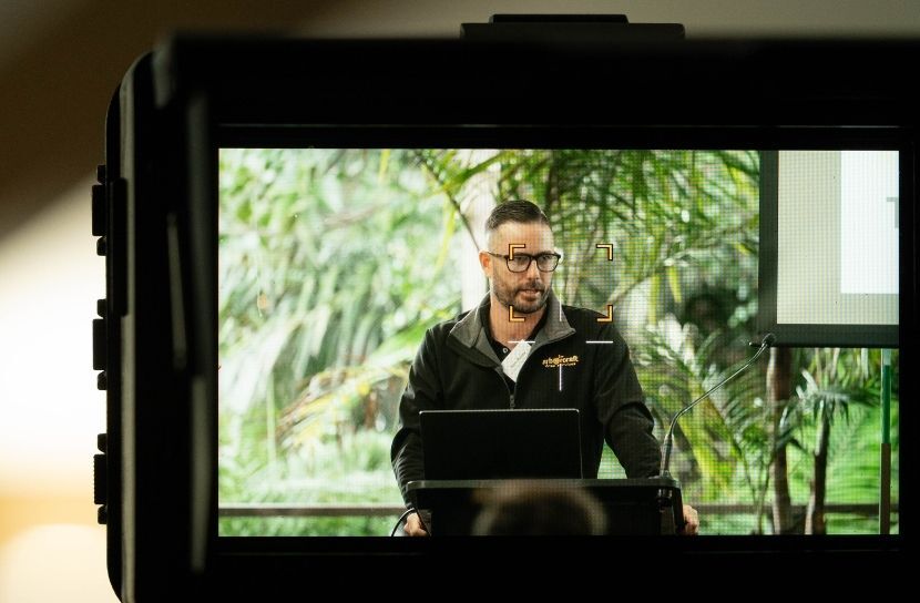 Camera shot of Sam Pusey speaking at Arborcraft event